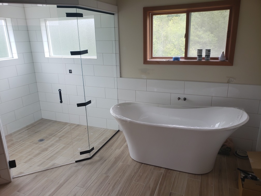 Remodeled bathroom with freestanding tub and tiled walk-in shower