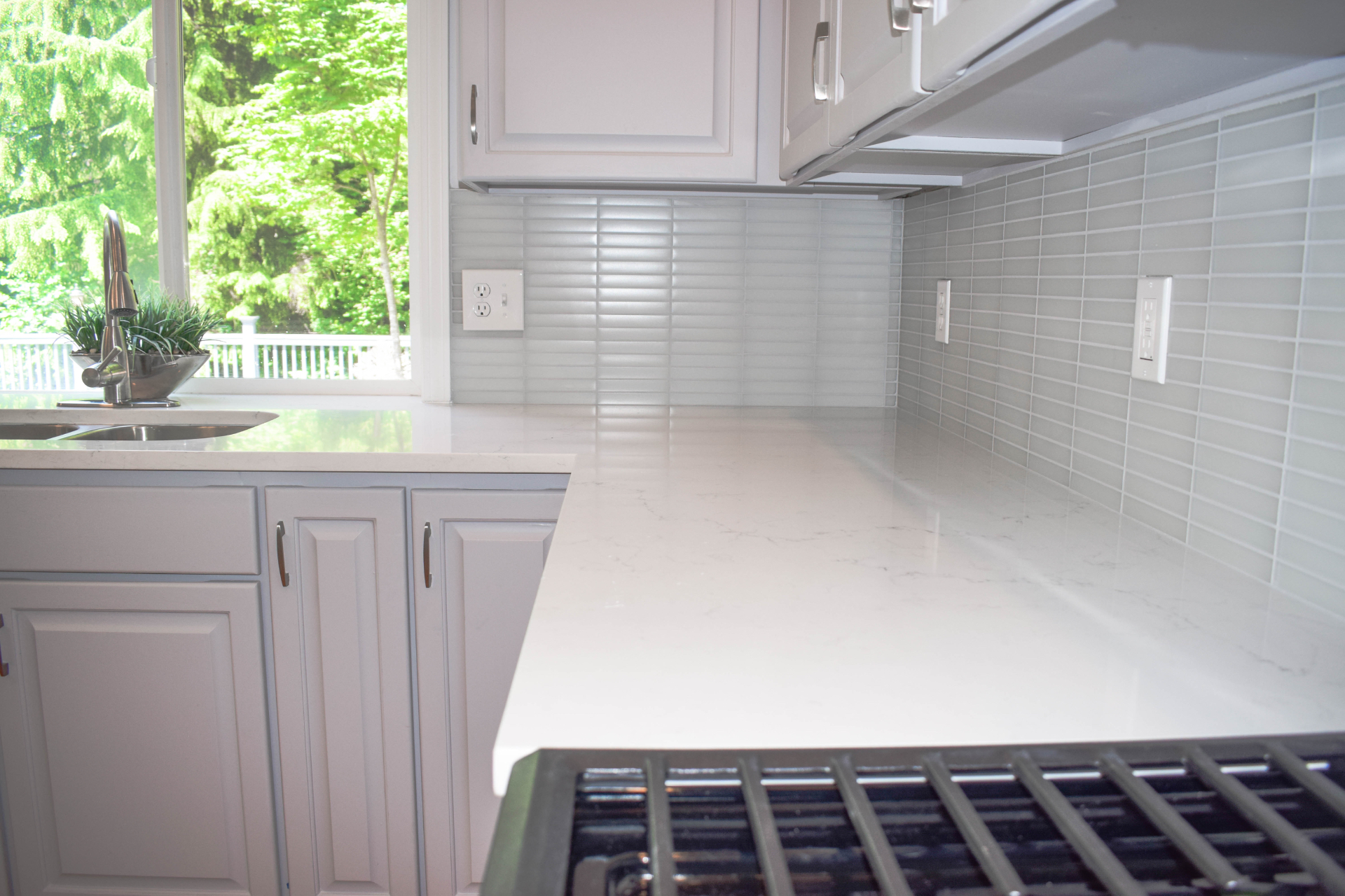 Glass tile kitchen backsplash with quartz countertop